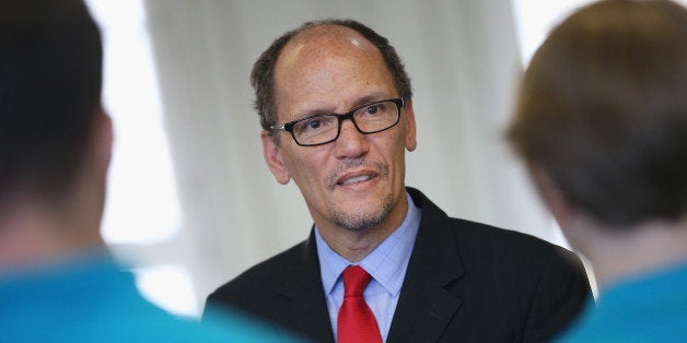 BERLIN, GERMANY - OCTOBER 28: U.S. Labor Secretary Thomas Perez chats with trainees at the Siemens training facility on October 28, 2014 in Berlin, Germany. Secretary Perez visited the center to learn more about the German trainee system, in which manufacturers offer paid multi-year training programs to recent high school graduates. U.S. President Obama has expressed interest in adopting the system in the U.S., where thus far training is usually conducted at technical or community colleges, as a way enhance job growth, meet the job requirements of U.S. industry and make the U.S. economy more competitive. (Photo by Sean Gallup/Getty Images)