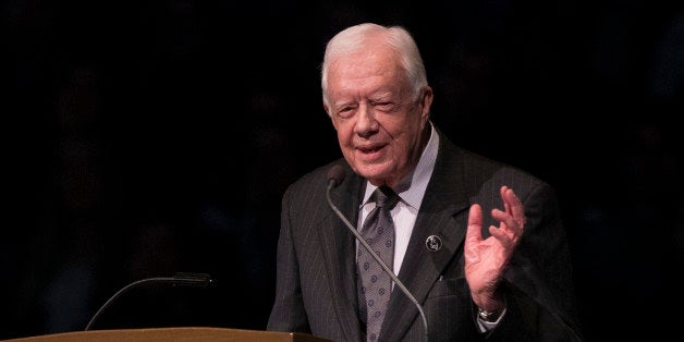 FILE - In this March 4, 2015, file photo, former President Jimmy Carter speaks during the memorial service for Rev. Theodore Hesburgh, inside the Purcell Pavilion at the University of Notre Dame in South Bend, Ind. Carter Center officials said Sunday, May 10, 2015, that the former President has cut short an election observation visit in Guyana due to health reasons. The statement from the Center says the 90-year-old ex-president is returning to Atlanta. It did not disclose specifics, only saying Carter was ânot feeling well.â(AP Photo/Robert Franklin, File)