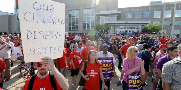 Demonstrates protest outside the school district headquarters, Thursday, May 30, 2013, in Philadelphia. Education officials plan to vote on what critics are calling a "doomsday" budget, an austere proposal that would force city schools to open next fall without resources like assistant principals, guidance counselors, athletics and music programs. (AP Photo/Matt Rourke)