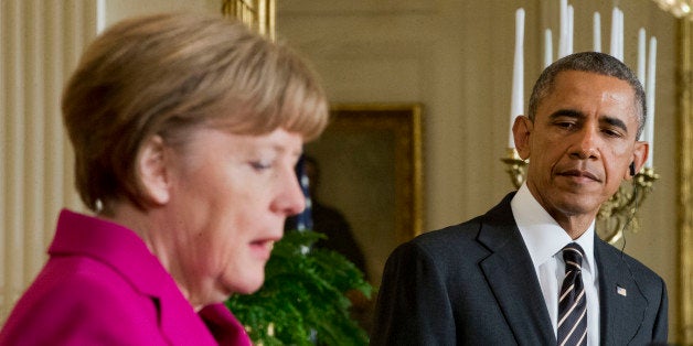 President Barack Obama, right, listen to German Chancellor Angela Merkel, left, during their joint news conference in the East Room of the White House in Washington, Monday, Feb. 9, 2015. The leaders were expected to discuss the ongoing conflict in Ukraine, and arming Ukrainian fighters to wage a more effective battle against Russian-backed separatists. (AP Photo/Pablo Martinez Monsivais)