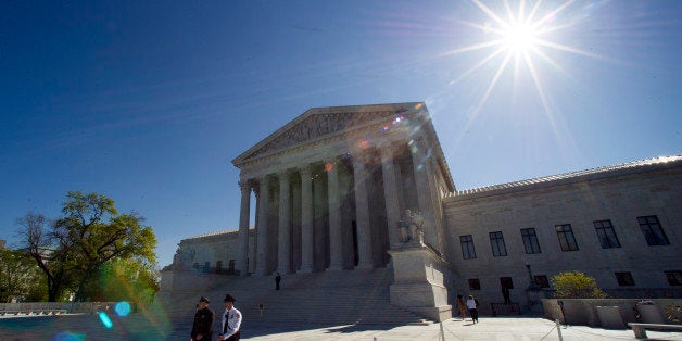 Supreme Court police officers walk on the plaza in front of the Supreme Court in Washington, Tuesday, April 28, 2015. The Supreme Court is set to hear historic arguments in cases that could make same-sex marriage the law of the land. The justices are meeting Tuesday to offer the first public indication of where they stand in the dispute over whether states can continue defining marriage as the union of a man and a woman, or whether the Constitution gives gay and lesbian couples the right to marry. (AP Photo/Cliff Owen)