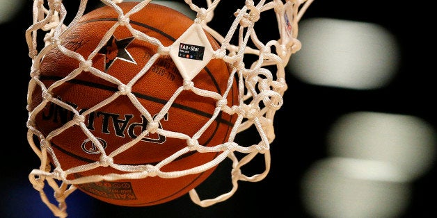 The NBA All-Star Game logo is seen on the net as World Team's Giannis Antetokounmpo, of the Milwaukee Bucks, shoots a free-throw during the second half of the Rising Stars Challenge against the U.S.Team, Friday, Feb. 13, 2015, in New York. (AP Photo/Julio Cortez)