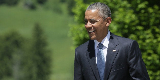 U.S. President Barack Obama walks toward the arrivals area prior to being greeted by German Chancellor Angela Merkel at the G-7 summit at Schloss Elmau hotel near Garmisch-Partenkirchen, southern Germany, Sunday, June 7, 2015. The two-day summit will address such issues as climate change, poverty and the situation in Ukraine. (AP Photo/Virginia Mayo)