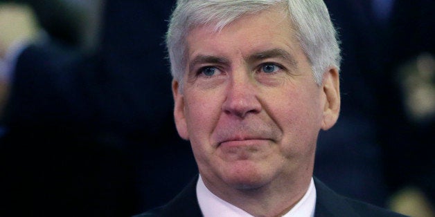 FILE - In this Feb. 11, 2015 file photo, Michigan Gov. Rick Snyder gets ready for an address in Lansing, Mich. Snyder used his extraordinary legal powers in December to pardon a politically connected lawyer who had a drunken driving conviction. (AP Photo/Carlos Osorio, File)