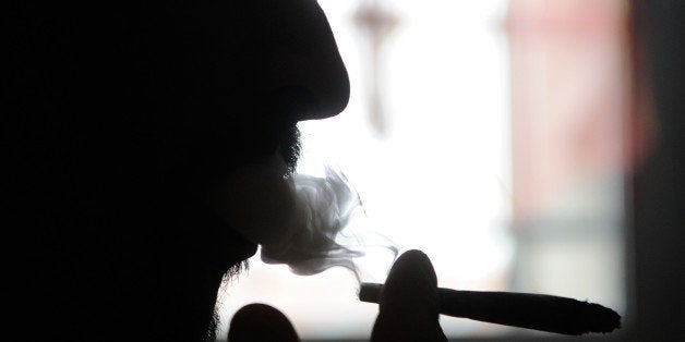 TO GO WITH AFP STORY BY ANGELA SCHNAEBELE
Dominique Loumachi, suffering from Dermatomyositis (Myopathy), smokes a cigarette