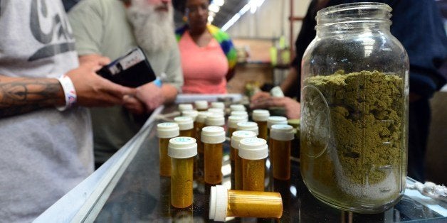 Card-carrying medical marijuana patients eager to learn more about Kief, in jar, at Los Angeles' first-ever cannabis farmer's market at the West Coast Collective medical marijuana dispensary, on the fourth of July, or Independence Day, in Los Angeles, California on July 4, 2014 where organizer's of the 3-day event plan to showcase high quality cannabis from growers and vendors throughout the state. Kief, which refers to the resin glands of cannabis that accumulates from sifting the loose dry cannabis flower with a sieve or mesh screen, has traditionally been pressed into cakes and called hashish. AFP PHOTO/Frederic J. BROWN (Photo credit should read FREDERIC J. BROWN/AFP/Getty Images)