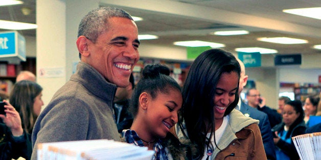 WASHINGTON, DC - NOVEMBER 29: (AFP OUT) U.S. President Barack Obama and daughters Sasha (C) and Malia purchase books at Politics and Prose bookstore for 'Small Business Saturday' on November 29, 2014 in Washington, DC. Retailers have begun to promote 'Small Business Saturday' to encourage shopping at independent stores amid the frenzy of Black Friday and Cyber Monday. (Photo by Dennis Brack/Black Star