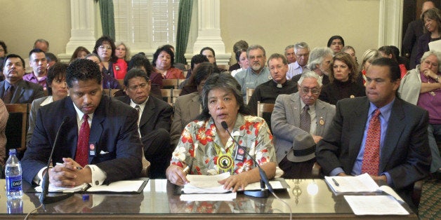 Appearing in an overflow hearing room, Priscilla Hunter, chairwoman of the Coyote Valley Band of Pomo Indians, center, was one of several tribal leaders who defended their labor practices, particularly in providing health care for casino workers, while appearing before an Assembly subcommittee hearing at the Capitol in Sacramento,Calif., Tuesday, April 1, 2003. A hearing of the Budget Subcommittee on Health and Human Services was held to discuss a report released this month, by the Intitute of Industrial Relations, at the University of California, Los Angeles, that said employees at Agua Caliente Casino purchase goverment health care for their families because they can't afford the casino's plan. Also seen are Eduardo G. Roy, attorney for the Pomo Band, left, and Anthony Miranda, second vice president of the Pechange Band of Luiseno Mission Indians, right.(AP Photo/Rich Pedroncelli)