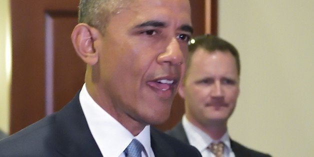 US President Barack Obama walks through a hallway after meeting with House Democrats at the US Capitol on June 12, 2015 in Washington, DC. President Barack Obama Friday went to Congress Friday for a frantic round of lobbying ahead of a crucial vote on his sweeping trans-Pacific trade agenda. The House of Representatives is expected to vote mid-day Friday on final passage of so-called Trade Promotion Authority, and while Republican leaders are confident they have the momentum to get it across the finish line, the vote remains a toss-up. AFP PHOTO/MANDEL NGAN (Photo credit should read MANDEL NGAN/AFP/Getty Images)