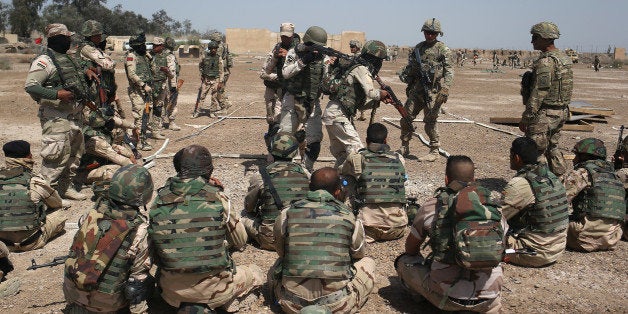 TAJI, IRAQ - APRIL 12: U.S. Army trainers instruct as Iraqi Army recruits at a military base on April 12, 2015 in Taji, Iraq. Members of the U.S. Army's 5-73 CAV, 3BCT, 82nd Airborne Division are teaching soldiers from the newly-formed 15th Division of the Iraqi Army, as the Iraqi government launches offensives to try to recover territory lost to ISIS last year. U.S. forces, currently operating in 5 large bases throught Iraq, are training thousands of Iraqi Army combat troops, trying to rebuild a force they had origninally trained before the U.S. withdrawal from Iraq in 2010. (Photo by John Moore/Getty Images)