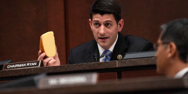 House Ways and Means Committee Chairman Rep. Paul Ryan, R-Wis., holds up a chunk of cheese as he questions U.S. Trade Representative Michael Froman during a hearing on US trade policy, Tuesday, Jan. 27, 2015, on Capitol Hill in Washington. (AP Photo/Susan Walsh)
