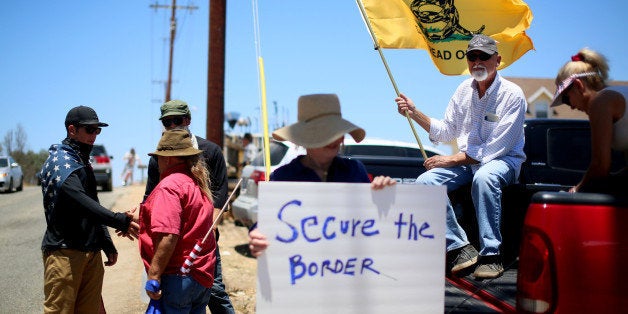 MURRIETA, CA - JULY 7: Anti-immigration activists protest outside of the U.S. Border Patrol Murrieta Station on July 7, 2014 in Murrieta, California. Immigration protesters have staged rallies in front of the station for about a week in response to a wave of undocumented immigrant children caught along the U.S.-Mexico border in Texas and transported to the Murrieta facility while awaiting deportation proceedings. (Photo by Sandy Huffaker/Getty Images)