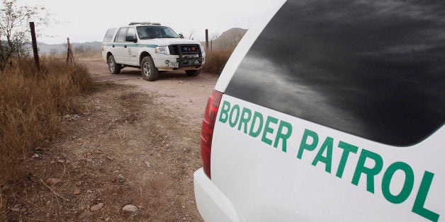 FILE - In this Thursday, Dec. 16, 2010 file photo, U.S. Border Patrol vehicles come and go from a checkpoint, as teams of border officers comb through the Arizona desert about 10 miles north of Mexico in search of the lone outstanding suspect in the fatal shooting of Border Patrol agent Brian Terry in the rugged terrain in Rio Rico, Ariz. The shooting Tuesday night came after agents spotted suspected bandits known for targeting illegal immigrants along a violent smuggling corridor. State Sen. Steve Smith, R-Maricopa, was the sponsor of a bill that was signed into law recently that will use donated money and inmate labor to build a "secure fence" along the U.S.-Mexico border. (AP Photo/Ross D. Franklin, file)