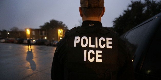 In this photo made Thursday, March 6, 2015, U.S. Immigration and Customs Enforcement agents enter an apartment complex looking for a specific undocumented immigrant convicted of a felony during an early morning operation in Dallas. The Department of Homeland Security has been conducting a nationwide roundup of undocumented immigrants convicted of felonies in order to deport them to their country of origin. (AP Photo/LM Otero)