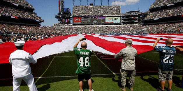 PHILADELPHIA, PA - SEPTEMBER 07: Members of the US Armed Forces and season ticket holders hold a large American Flag along with with members of the Jacksonville Jaguars and Philadelphia Eagles before the start of a game at Lincoln Financial Field on September 7, 2014 in Philadelphia, Pennsylvania. The Eagles defeated the Jaguars 34-17. (Photo by Rich Schultz /Getty Images)