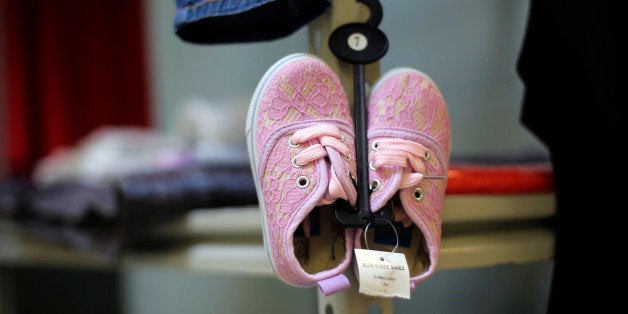 A pair of new shoes are seen at the Karnes County Residential Center in Karnes City, Texas on Thursday, July 31, 2014. Federal officials gave a tour of the South Texas immigration detention facility that has been retooled to house adults with children who have been apprehended at the border. (AP Photo/Eric Gay)