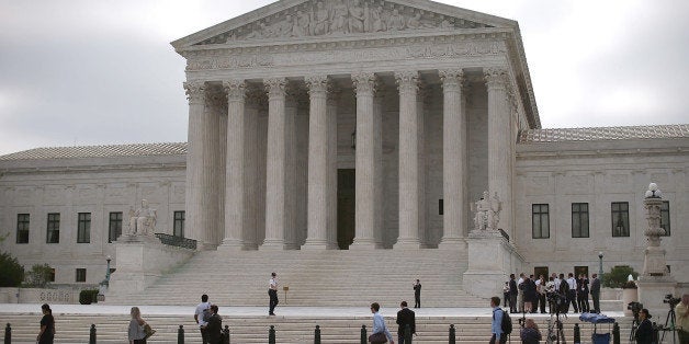WASHINGTON, DC - JUNE 18: People gather in front of the Supreme Court Building June 18, 2015 in Washington, DC. This month t