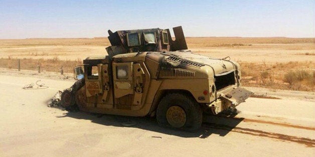 A destroyed Iraqi army humvee is left behind outside of the northern city of Mosul, Iraq, Wednesday, June 25, 2014, more than