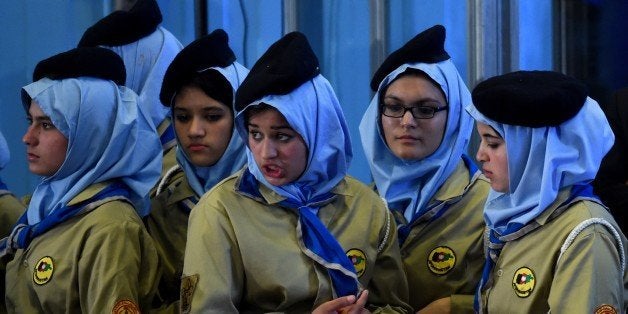 Afghan students look on during a ceremony attended by Afghan President Ashraf Ghani marking the start of the new school year at Amani High School in Kabul on March 19, 2015. President Ghani said deprivation of children from school and closure of schools are enmity against Islam and Afghanistan. Over 8 million Afghans are going to schools, and 42 percent of them are girls, a great achievement for Afghan girls as they were banned during the Taliban regime before 2001. AFP PHOTO / WAKIL Kohsar (Photo credit should read WAKIL KOHSAR/AFP/Getty Images)