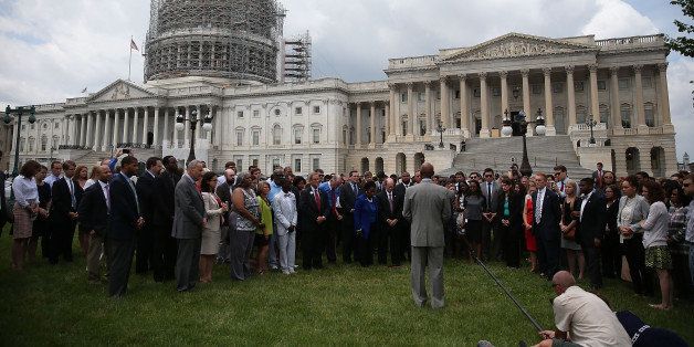 WASHINGTON, DC - JUNE 18: Members of the US House ofÃRepresentatives and members of the US Senate and staff gather in a prayer circle in front of the US Capitol to honor those gunned down last night inside the historic Emanuel African Methodist Episcopal Church in Charleston South Carolina, June 18, 2015 in Washington, DC. Police have arrestedÃDylann Roof, 21, of Lexington, South Carolina in the shooting that killed 9 people. (Photo by Mark Wilson/Getty Images)
