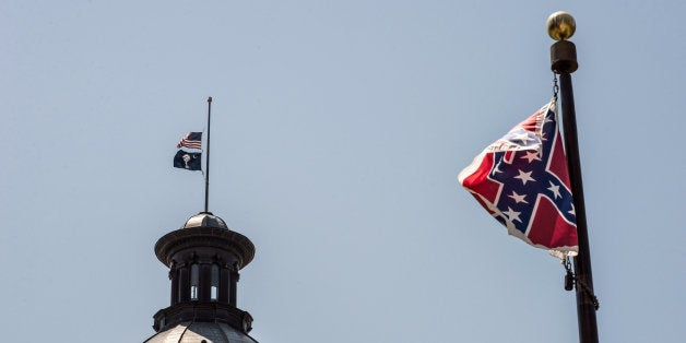 COLUMBIA, SC - JUNE 18: The South Carolina and American flags fly at half mast as the Confederate flag unfurls below at the