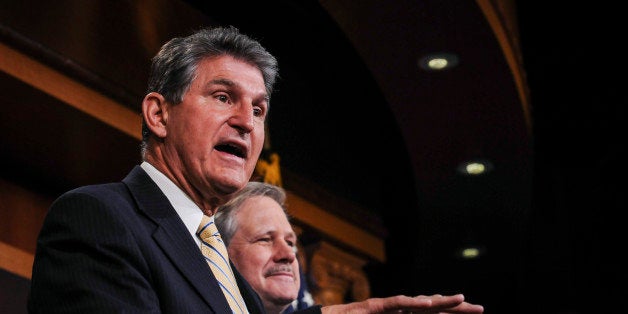 WASHINGTON, DC - JANUARY 6: Sen. Joe Manchin (D-WV) (L), and Sen. John Hoeven (R-ND) (R), speak to reporters at a news conf
