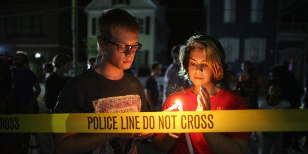 CHARLESTON, SC - JUNE 18: Mourners light candles for the nine victims of last night's shooting at the historic Emanuel African Methodist Episcopal Church June 18, 2015 in Charleston, South Carolina. Dylann Storm Roof, 21, of Lexington, South Carolina, who allegedly attended a prayer meeting at the church for an hour before opening fire and killing three men and six women, was arrested today. Among the dead is the Rev. Clementa Pinckney, a state senator and a pastor at Emanuel AME, the oldest black congregation in America south of Baltimore, according to the National Park Service. (Photo by Chip Somodevilla/Getty Images)