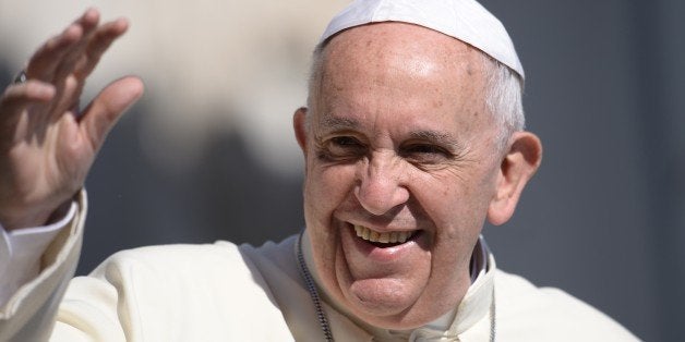 Pope Francis greets the crowd as he arrives for his general audience at St Peter's square on June 10, 2015 at the Vatican. AFP PHOTO / FILIPPO MONTEFORTE (Photo credit should read FILIPPO MONTEFORTE/AFP/Getty Images)