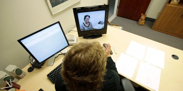 In this Sept. 22, 2010 photo, a doctor, foreground, in Des Moines, Iowa, and a nurse in a clinic in another city, demonstrate a telemedicine program with which Planned Parenthood of the Heartland clinic doctors can remotely prescribe the abortion-inducing drug RU-486. (AP Photo/Charlie Neibergall)