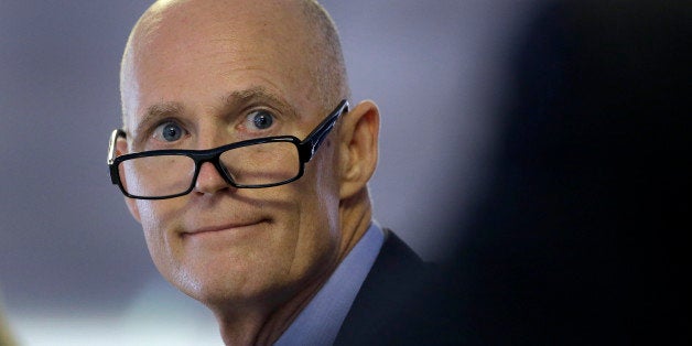 Florida Gov. Rick Scott looks over at cabinet members during a meeting at the fairgrounds during the opening of the Florida State Fair, Thursday, Feb. 5, 2015, in Tampa, Fla. Scott is saying Thursday that he mishandled the ouster of Gerald Bailey, the head of Floridaâs main law enforcement agency. Scott made the statement at the start of Thursdayâs meeting of the governor and Cabinet. (AP Photo/Chris O'Meara)