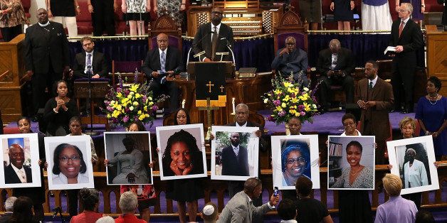 WASHINGTON, DC - JUNE 19: Photographs of the nine victims killed at the Emanuel African Methodist Episcopal Church in Charleston, South Carolina are held up by congregants during a prayer vigil at the the Metropolitan AME Church June 19, 2015 in Washington, DC. Earlier today the suspect in the case, Dylan Storm Roof, was charged with nine counts of murder. (Photo by Win McNamee/Getty Images)