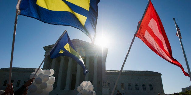 Equality flags fly in front of the Supreme Court in Washington, Tuesday, April 28, 2015. The Supreme Court is set to hear historic arguments in cases that could make same-sex marriage the law of the land. The justices are meeting Tuesday to offer the first public indication of where they stand in the dispute over whether states can continue defining marriage as the union of a man and a woman, or whether the Constitution gives gay and lesbian couples the right to marry. (AP Photo/Cliff Owen)