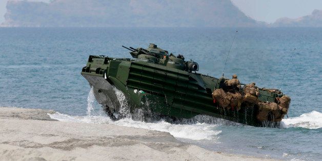 A U.S. Navy's amphibious assault vehicle with Philippine and U.S. troops on board storms the beach at a combined assault exercise at a beach facing one of the contested islands in the South China Sea known as the Scarborough Shoal in the West Philippine Sea Tuesday, April 21, 2015 at the Naval Education and Training Command at San Antonio township, Zambales province, northwest of Manila, Philippines. More than ten thousand troops from both the US and Philippine militaries are taking part in the annual military drill that focuses on regional security, terrorism, disaster preparedness and inter-operability of both countries. AP Photo/Bullit Marquez)
