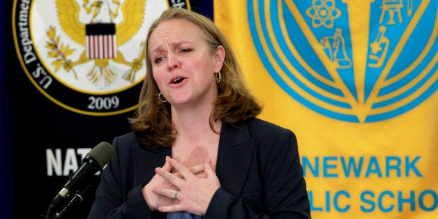 FILE - In this May 4, 2011 file photo, Cami Anderson gestures while talking to the media after being named chief of the state-run Newark Public School system in Newark, N.J. More than three years after Facebook founder Mark Zuckerberg committed $100 million toward remaking Newarkâs struggling schools, the district is engulfed in a dispute over proposed large-scale teacher layoffs that is threatening to derail wider reform efforts. Nearly half the money has been invested in a 2012 teacher contract that was hailed by Republican Gov. Chris Christie and the nationâs top teacherâs union official as an example of adversaries joining forces to rebuild a struggling urban school district. But the implementation of the contract, including a dispute over emphasizing teacher performance in determining layoffs, has devolved into a bitter fight between Anderson and teachers unions over the future of New Jerseyâs largest school district. (AP Photo/Julio Cortez)