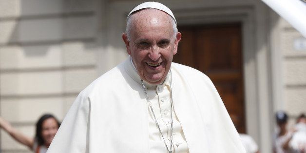 Pope Francis smiles as he arrives at the Santa Maria Ausiliatrice Basilica, in Turin, Italy, Sunday, June 21, 2015. Pope Francis earlier prayed in front of the Holy Shroud, the 14 foot-long linen revered by some as the burial cloth of Jesus, on display at the Cathedral of Turin. (AP Photo/Luca Bruno)