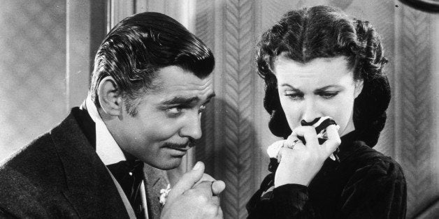 American actor Clark Gable (1901 - 1960) in his role as Rhett Butler kissing the hand of a tearful Scarlett O'Hara, played by Vivien Leigh in 'Gone With The Wind'. (Photo by Hulton Archive/Getty Images)