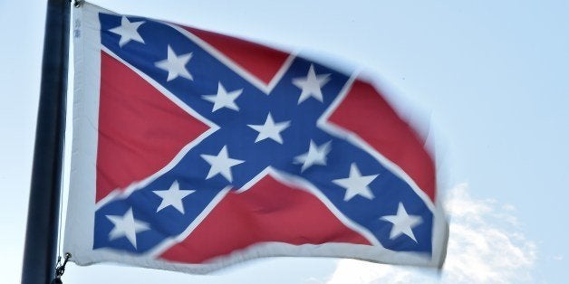 The Confederate flag is seen next to the monument of the victims of the Civil War in Columbia, South Carolina on June 20, 201