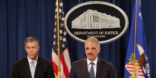 WASHINGTON, DC - MAY 13: U.S. Attorney General Eric Holder (R) and Education Secretary Arne Duncan hold a news conference at the Justice Department May 13, 2014 in Washington, DC. Holder announced that the Justice Department has reached a $60 million settlement with Sallie Mae after it was discovered the student load giant charged roughly 60,000 military service members excessive interest rates on their education loans. (Photo by Chip Somodevilla/Getty Images)