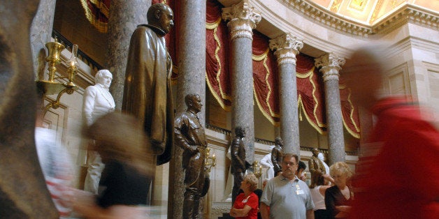 ** ADVANCE FOR MONDAY, JULY 23 ** Tour groups walk through Statuary Hall in the Capitol Friday, July 20, 2007, in Washington. Unlike states, the District of Columbia lacks a full vote in Congress, a well known fact that has inspired rallies and the popular "Taxation without Representation" license plates. But lesser known is the district's lack of representation in the Capitol's Statuary Hall, where only the 50 states can showcase their famous figures in bronze or marble. (AP Photo/Kevin Wolf)