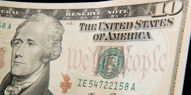 A close-up of the front of the US 10-dollar bill bearing the portrait of Alexander Hamilton, America's first Treasury Secreta