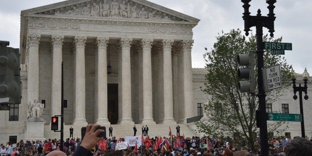 People gather outside the Supreme Court in Washington, DC on June 26, 2015 after its historic decision on gay marriage. The US Supreme Court ruled Friday that gay marriage is a nationwide right, a landmark decision in one of the most keenly awaited announcements in decades and sparking scenes of jubilation. The nation's highest court, in a narrow 5-4 decision, said the US Constitution requires all states to carry out and recognize marriage between people of the same sex. AFP PHOTO/ MLADEN ANTONOV (Photo credit should read MLADEN ANTONOV/AFP/Getty Images)