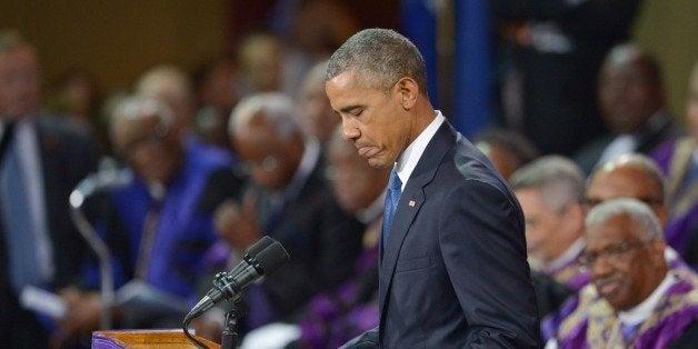 US President Barack Obama delivers the eulogy during the funeral of slain pastor, Rev. and South Carolina State Sen. Clementa Pinckney, at the College of Charleston TD Arena, in Charleston, South Carolina on June 26, 2015. US President Barack Obama made a fresh pitch for tighter gun controls as he eulogized the pastor killed in the Charleston church shootings, saying Americans had ignored the toll of gun violence for too long. AFP PHOTO/MANDEL NGAN (Photo credit should read MANDEL NGAN/AFP/Getty Images)