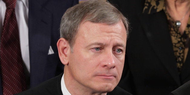 WASHINGTON, DC - JANUARY 28: U.S. Supreme Court Chief Justice John Roberts (L) and Associate Justice Anthony Kennedy listen