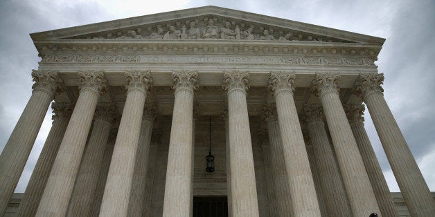 WASHINGTON, DC - AUGUST 20: A guard stands on the steps of the Supreme Court Building, August 20, 2014 in Washington, DC. Today the high court blocked gay and lesbian couples from marrying in Virginia and puts on hold a federal appeals court's verdict last month striking down the state's ban on gay marriage. (Photo by Mark Wilson/Getty Images)