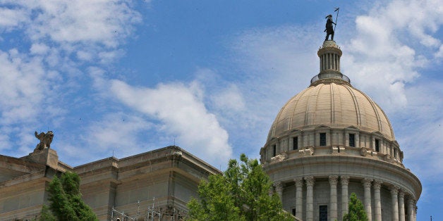 Workers build scaffolding at the state Capitol in Oklahoma City, Thursday, June 11, 2015. Assessments and test phases of exterior repair are beginning on the nearly 100-year-old building. The Oklahoma Legislature approved a $120 million bond issue last year to pay for renovations to the building. (AP Photo/Sue Ogrocki)