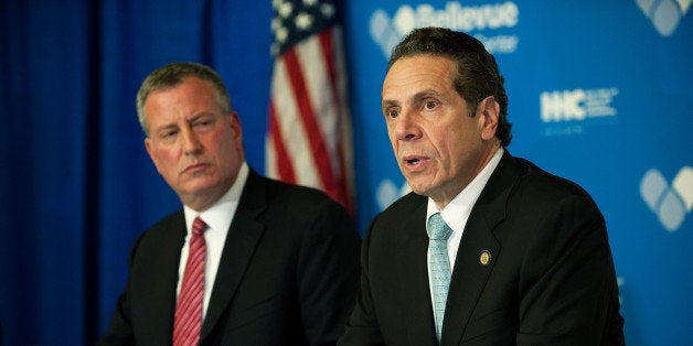 NEW YORK, NY - OCTOBER 23, 2014: Mayor Bill de Blasio of New York City and Governor Andrew Cuomo of New York speak at a press conference October 23, 2014 in New York City. Mayor de Blasio and Governor Cuomo addressed Dr. Craig Spencer, who had returned to New York City from Guinea where he was working with Doctors Without Borders treating Ebola patients. Spencer had been quarantined after showing symptoms consistent with the virus and was taken to Bellevue hospital to undergo testing. According to reports, test results have confirmed that Spencer has contracted the Ebola virus. (Photo by Bryan Thomas/Getty Images)