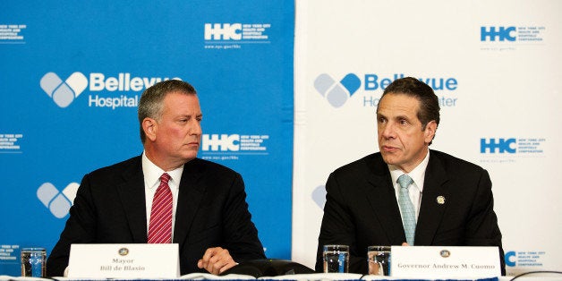 NEW YORK, NY - OCTOBER 23: Mayor Bill de Blasio of New York City and Governor Andrew Cuomo of New York speak at a press conference October 23, 2014 in New York City. Mayor de Blasio and Governor Cuomo addressed Dr. Craig Spencer, who had returned to New York City from Guinea where he was working with Doctors Without Borders treating Ebola patients. Spencer had been quarantined after showing symptoms consistent with the virus and was taken to Bellevue hospital to undergo testing. According to reports, test results have confirmed that Spencer has contracted the Ebola virus. (Photo by Bryan Thomas/Getty Images)