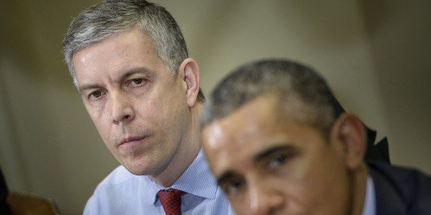 US Secretary of Education Arne Duncan (L) listens while US President Barack Obama makes a statement to the press after a meeting with the Council of the Great City Schools Leadership in the Roosevelt Room of the White House March 16, 2015 in Washington, DC. Obama spoke about the education budget. AFP PHOTO/BRENDAN SMIALOWSKI (Photo credit should read BRENDAN SMIALOWSKI/AFP/Getty Images)