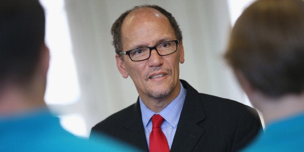 BERLIN, GERMANY - OCTOBER 28: U.S. Labor Secretary Thomas Perez chats with trainees at the Siemens training facility on Octo