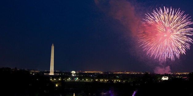 WASHINGTON, DC - JULY 4: In this handout image provided by the White House, A crowd watches from the South Lawn of the White House as fireworks erupt over the National Mall on July 4, 2012 in Washington, DC. (Photo by Pete Souza/White House Photo via Getty Images)